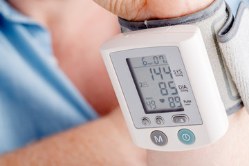 health problem, high blood pressure. Man measuring his blood pressure