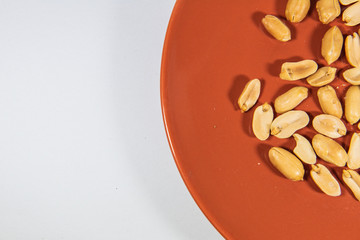 Nut in orange ceramic plate.