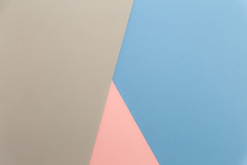 Multicolor background from cardboard of different colors. Pastel paper color for background. Colorful abstract geometric shapes. Pastel colored paper texture minimalism background. Pink, Blue, Grey.