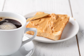 Fat man eat typical high-calorie breakfast with toast and peanut butter