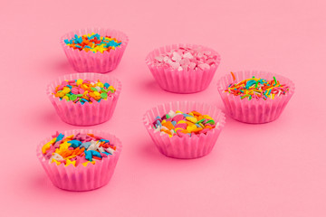 Sugar sprinkles  food background on pink cardboard