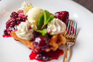 Belgian waffles with ice cream and berries