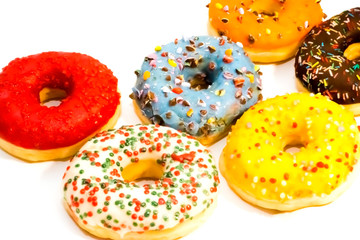 Sweet tasty donuts with colorful sprinkles isolated on white background