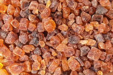 Healthy cane sugar on a wooden brown background
