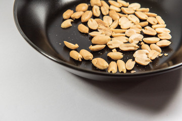 Nuts in black ceramic plate.