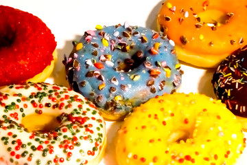 Sweet tasty donuts with colorful sprinkles isolated on white background