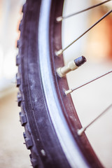 Bike in the city: Close up picture of the tyre outlet and spokes