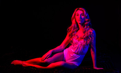 Feeling confident and sexy. Pin up sexual woman in bodysuit. Sensual girl with fit body in red light. Fashion sexual beauty. Sexy woman in erotic lingerie. Blond curly hair. Pinup look. sexual woman