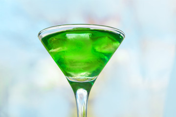 drink in a martini glass with ice cubes.