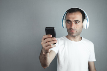 Caucasian man with headphones. Listening music