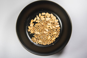 Mixed nuts in ceramic plate.Sunflower seeds snack ready to eat.