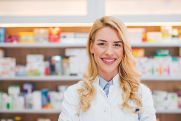 Close-up portrait of smiling druggist at drugstore.