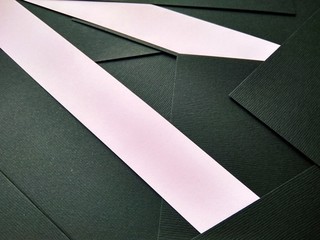 few black papers folded with color paper close up