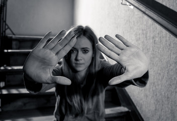 Sad young teen girl showing the hands in Stop Violence,abuse, and cyber bullying.