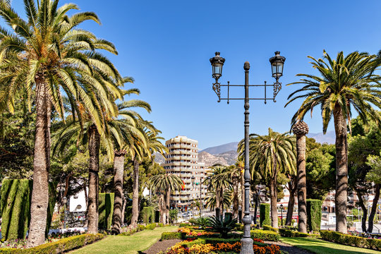 View of public park and downtown buildings in Motril in Andalusia, Spain.