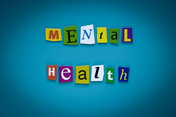 Obraz premium A word writing text - mental health - of cut letters on a blue background. Headline - mental health. Banner with inscription - mental health. Psychologic concept.