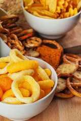 Beer snacks on stone and wooden background. Top view, copy space