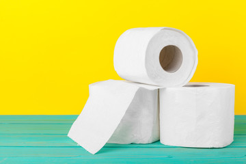 Toilet paper stacks  on bright yellow background