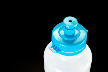 Plastic transparent bottle with blue cap for cycling and fitness.