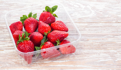 red strawberries group of berries in container