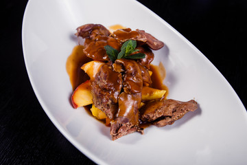 Duck liver with berry sauce and apples decorated with rosemary