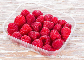 group berries raspberries on wooden table