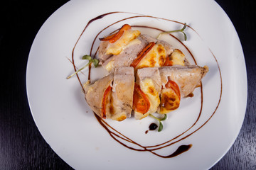 Spicy chicken fillet baked with bacon, tomatoes and cheddar cheese