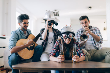 Group of happy young friends having fun and drinking beer