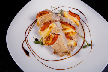 Spicy chicken fillet baked with bacon, tomatoes and cheddar cheese