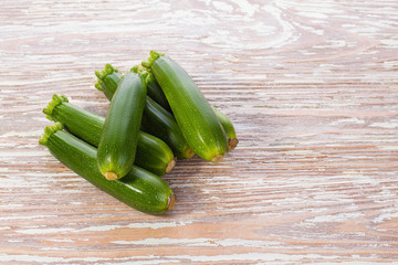fresh raw zucchini on wooden tabletop