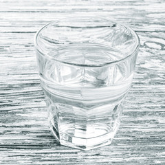 wooden background with glass of water