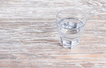 wooden background with glass of water
