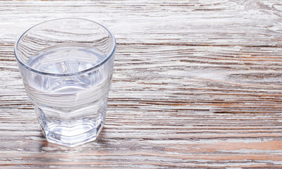 wooden background with glass of water