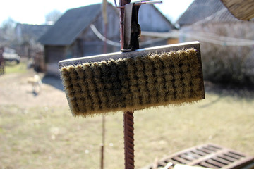 Dirty brush hanging on the roof