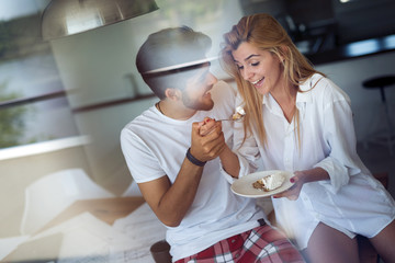 Cute young cheerful couple spending time at home