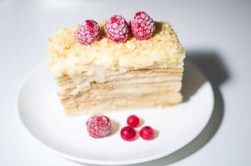 cake with raspberries and currants on a plate
