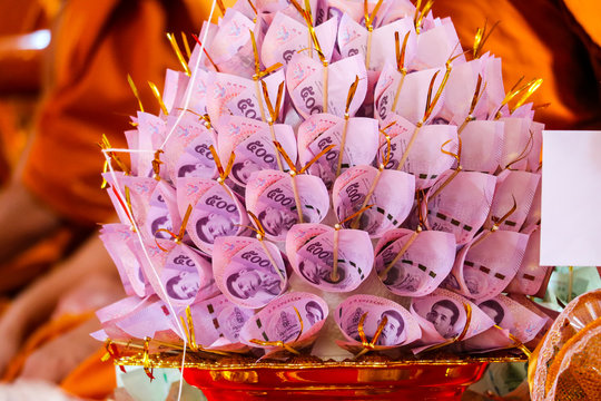 Banknotes are finely folded to decorate on the golen plate to give to the Buddhist temple
