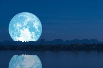 full milk moon back on silhouette mountain and reflection on river night sky