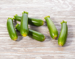 fresh raw zucchini on wooden tabletop