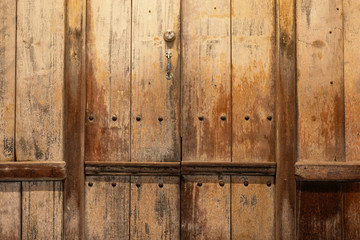 Old wooden planks use for texture and background..Close up of wooden door shopfront in old town market with evening light..