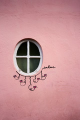 Window and pink wall with wall art 