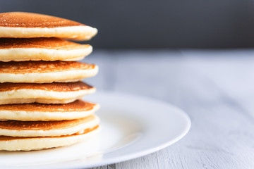 fresh classic pancake stacked in stack on gray background with place for text