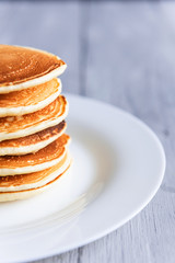 fresh classic pancake stacked in stack on gray background with place for text