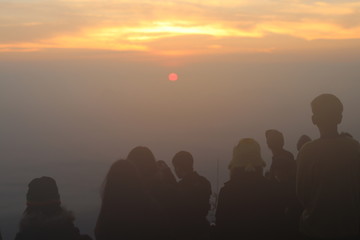 people on mountain at sun rise