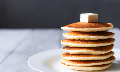 fresh classic pancake stacked in stack on gray background with place for text