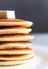 fresh classic pancake stacked in stack on gray background with place for text