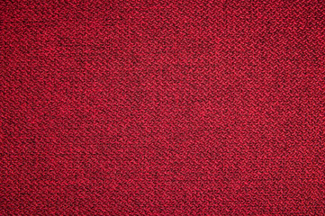 Textured background surface of textile upholstery furniture close-up. red Color fabric structure