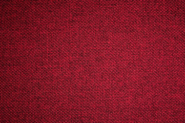 Fototapeta premium Textured background surface of textile upholstery furniture close-up. red Color fabric structure