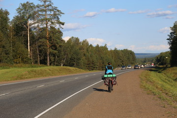 Fototapeta premium man riding a bike on country road