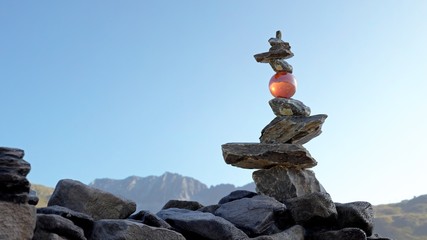 Tower of stones in balance (Rock Balance) with a crystal sphere holding the upper stones.